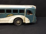 a toy bus that is sitting on a black surface