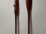 pair of wooden paddles on a white background with a gray background
