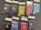 six pairs of children ' s socks with pink bows on them