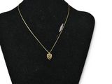 a gold necklace with a heart pendant on a mannequin