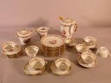 a lot of plates and cups that are on a table