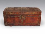 an old wooden trunk with ornate carvings and rivets on the sides