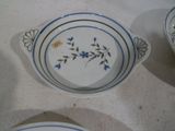 three plates with blue flowers on them on a table