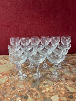 six empty wine glasses sitting on a table with a red background