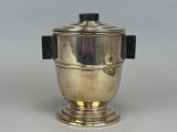 an antique silver plated teapot with a black lid and a black handle