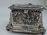 a silver box with a picture of a man and a woman on it