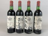 three bottles of wine are lined up in a row on a table