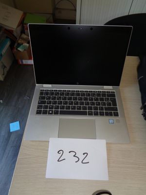 a laptop computer sitting on top of a wooden desk