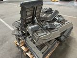 a pile of electronics sitting on top of a pallet in a parking lot