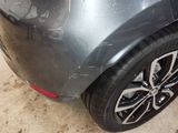a close up of a car ' s rear end with a lot of scratches on it