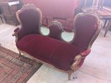 a red couch with a mirror on it in a living room