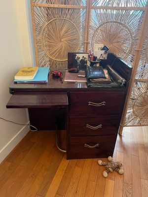 an image of a desk in a room with a window