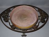 a pink bowl sitting on top of a metal stand