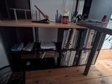 a desk with a book shelf and a chair in front of it