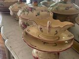 many plates and bowls on the counter in the kitchen
