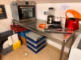a kitchen with a microwave and a lot of dishes on the counter