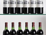 several bottles of wine are lined up on a glass shelf