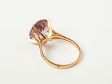 a close up of a gold ring with an amethorate stone