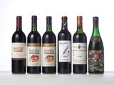 six bottles of wine are lined up on a table
