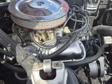 a close up of a car ' s engine with the hood open