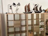 a room with a lot of bookshelves and a shelf with a boat on it