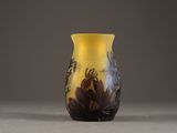a yellow vase with a black and white design on it