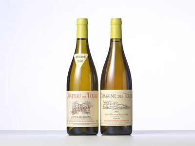 two bottles of wine sitting on top of a table next to each other