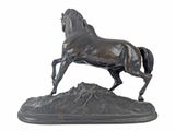bronze statue of a horse standing on a rock on a white background