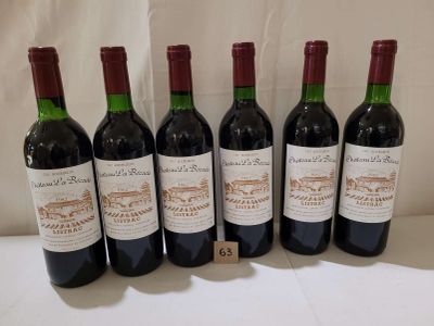 six bottles of wine are lined up on a table