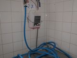a blue hose that is connected to a white wall