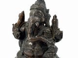 a statue of an elephant holding a bird in its hand