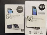 two boxes of cell phones sitting on top of a black table