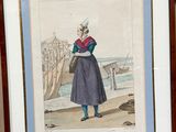 framed picture of a woman in a blue dress and hat standing by a body of water