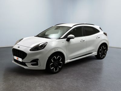 a white car parked in a room with a black floor