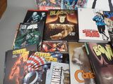 a lot of comic books sitting on a table