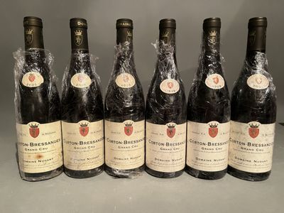 six bottles of wine are lined up in a row on a table