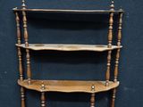 a wooden shelf with three shelves on each side of it