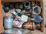 a cardboard box filled with assorted items and a mirror
