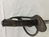 a sword that is on display on a white surface
