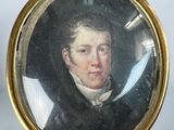an old picture of a man in a black coat with a feather in his hand