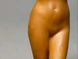 statue of a nude woman holding her hands up to her head