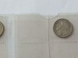 four gold coins sitting on top of a white curtain