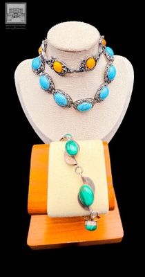 necklace and bracelet with turquoise and yellow beads on display on wooden stand
