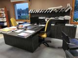 a desk with a chair and a computer on it