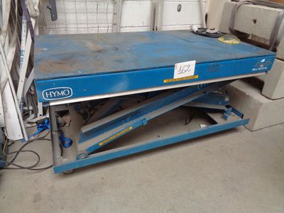 une paire de ciseaux bleus posée sur une table dans un garage
