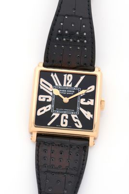 an image of a black and gold wrist watch with roman numerals