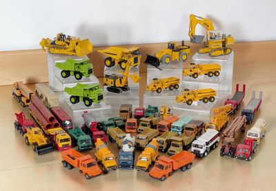 a lot of toy trucks that are sitting on the floor