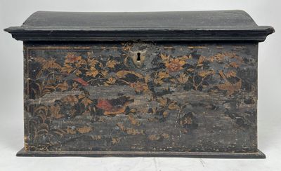 une vieille boîte en bois dont le couvercle est orné d'un motif floral