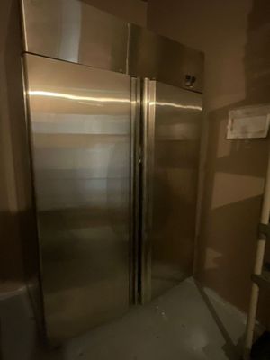 a large stainless steel refrigerator in the corner of a room