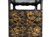 an image of a black and gold chest of drawers on a white background